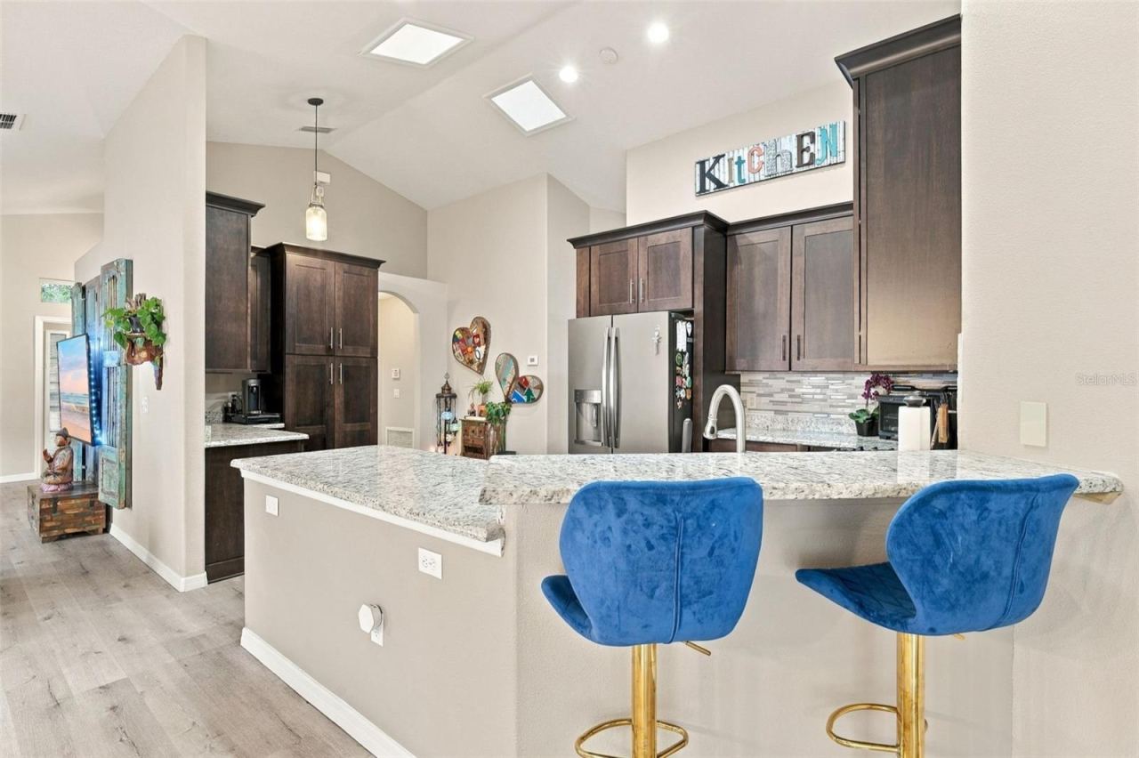 Photo 9 of 20: The split breakfast bar allows the kitchen to flow seamlessly to the dining area.