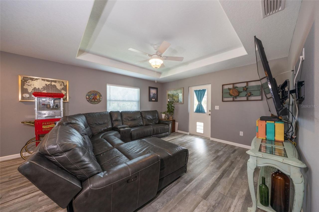 Photo 10 of 20: Tray ceiling in the spacious family room. Door leads to front deck