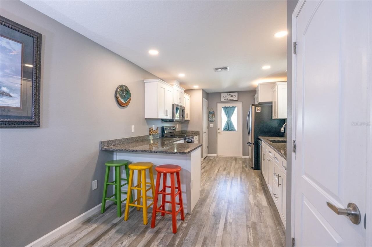 Photo 7 of 20: Bright kitchen leading to rear deck, backyard oasis & apartment or in-law suite