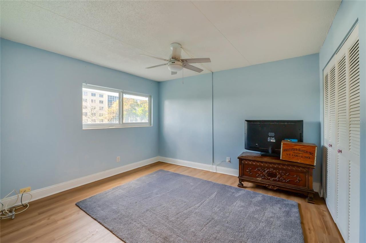 Photo 19 of 20: Versatile bedroom with a large window, ceiling fan, and ample floor space, suitable for a variety of uses.