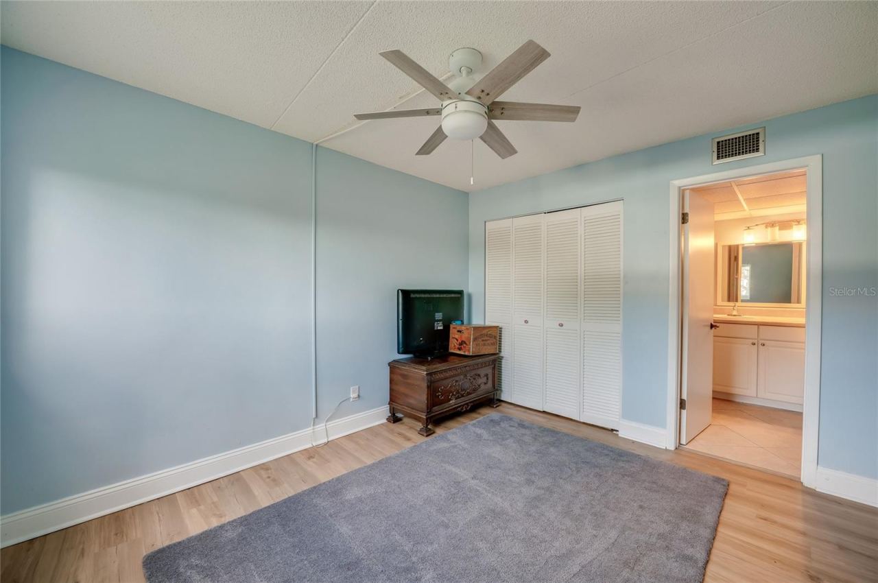 Photo 20 of 20: Bright and airy bedroom featuring a ceiling fan, ample closet space, and direct access to the en-suite vanity area.