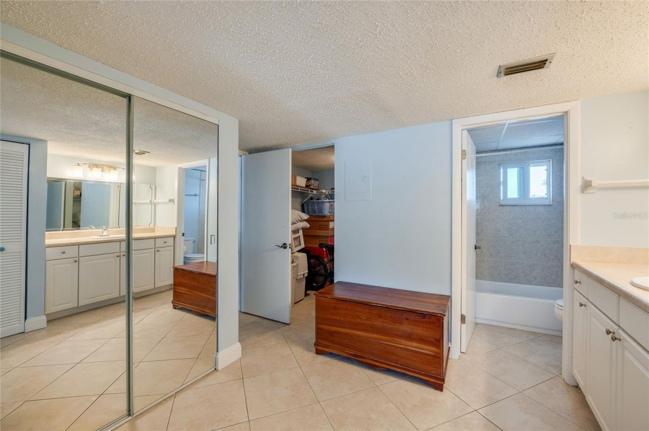Photo 17 of 20: Thoughtfully designed layout connecting the vanity, walk-in closet, and en-suite bath, offering functional flow and generous storage options.