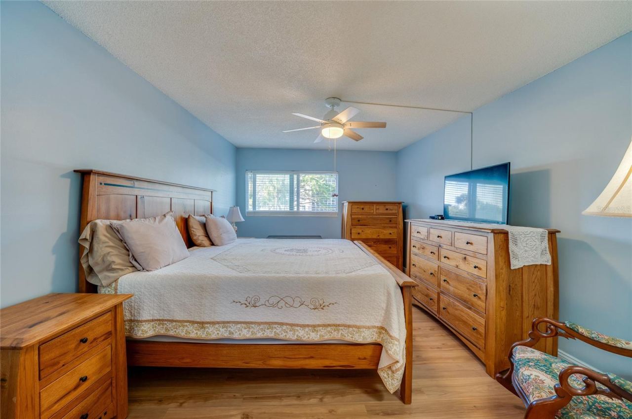 Photo 14 of 20: Comfortable and inviting bedroom with soft natural light, neutral tones, and plenty of space for full furnishings.
