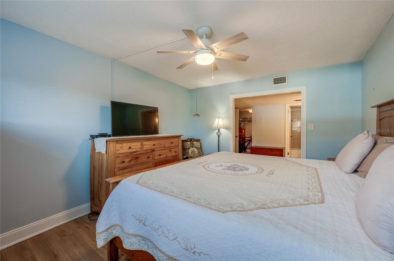 Photo 15 of 20: Another angle showcasing the room’s size, ceiling fan, and seamless connection to the en-suite bath and closet.