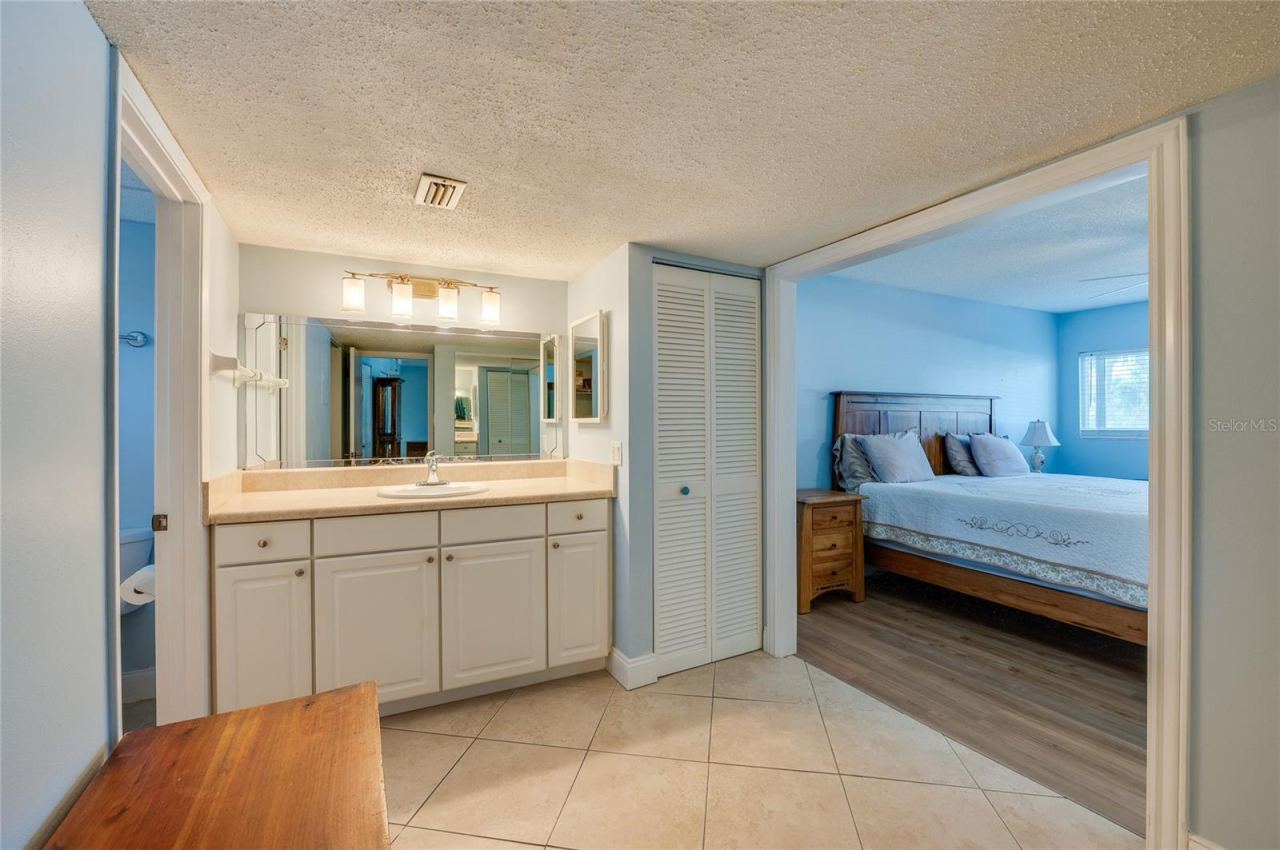 Photo 16 of 20: Spacious vanity area featuring an extended countertop, ample cabinetry, and a large mirror with bright overhead lighting for everyday convenience.