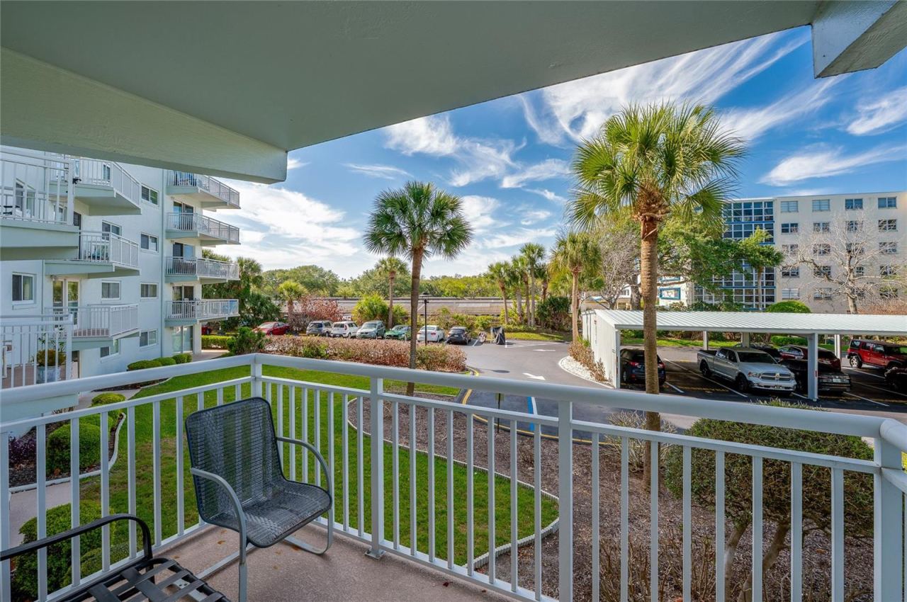 Photo 12 of 20: Private covered balcony overlooking the community, offering a peaceful spot to enjoy fresh air and morning coffee.