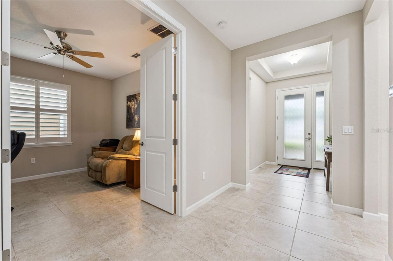 Photo 3 of 20: Foyer entryway w/ tray ceiling, waterfall glass front door & ceramic tile flooring