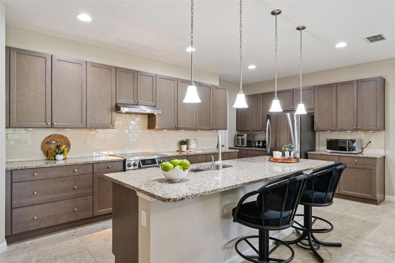 Photo 6 of 20: 18'6 x 10' Kitchen w/ 42" Taupe cabinets, Pot & Pan drawers & granite countertop