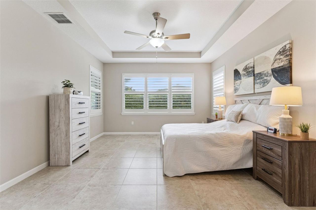 Photo 16 of 20: Primary Bedroom w/ multiple windows providing natural light & a view to the private backyard