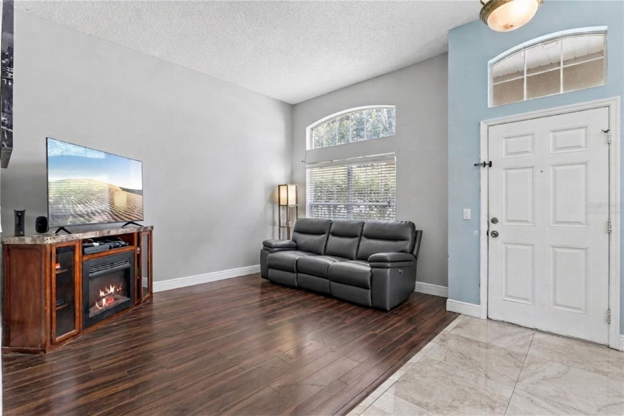 Photo 9 of 20: Main living room with tall ceilings and natural light. virtually staged.