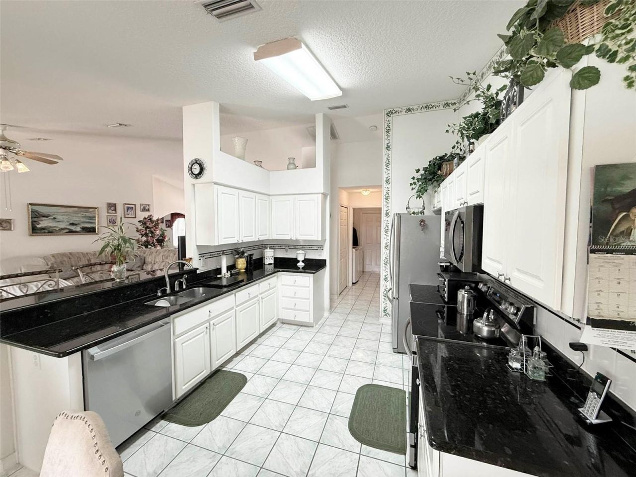 Photo 16 of 20: Kitchen with granite countertops & stainless steel appliances