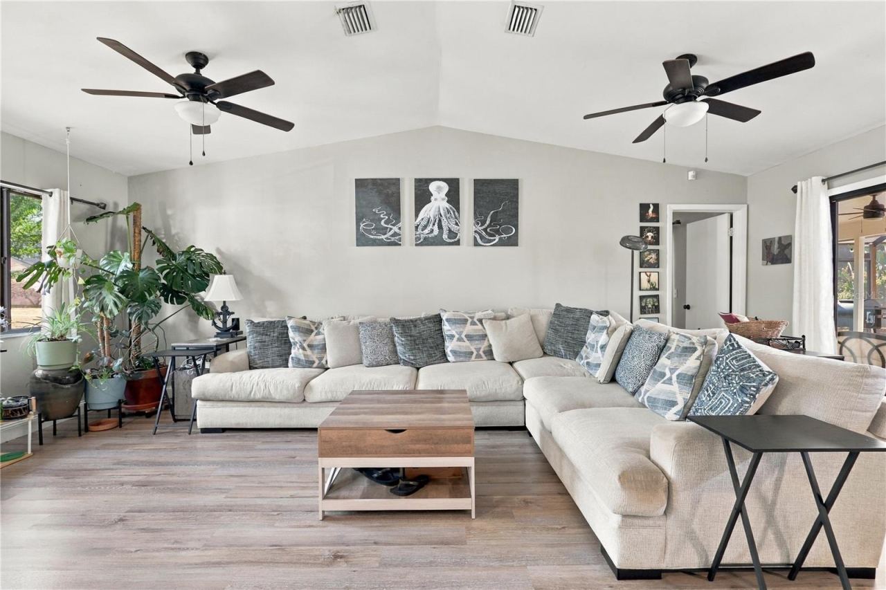Photo 7 of 20: Beautiful, Open Living Room, Vaulted Ceilings, Double Ceiling Fans & Sliding Glass Door to the Pool, Spa & Lanai.