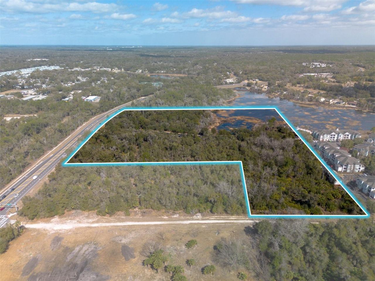 Photo 3 of 12: Unpaved Rhode Island Rd planned to connect east to Normandy, across I-4.