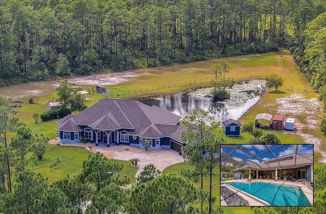 Photo 1 of 20: Expansive private home surrounded by dense green forest, a scenic pond, and a long paved driveway.