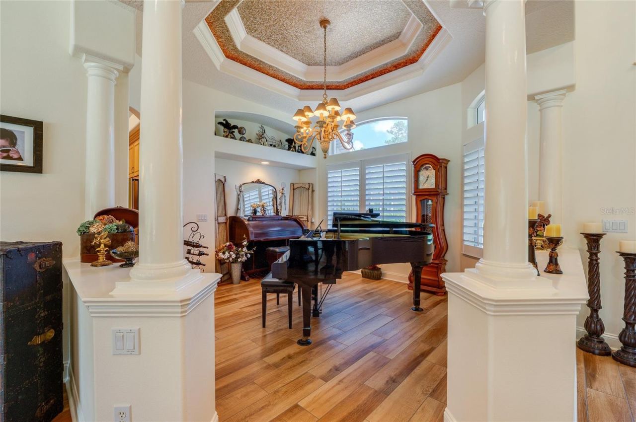 Photo 9 of 20: Architecturally detailed formal space highlighted by grand support columns, an intricate tray ceiling, and bright natural light throughout.