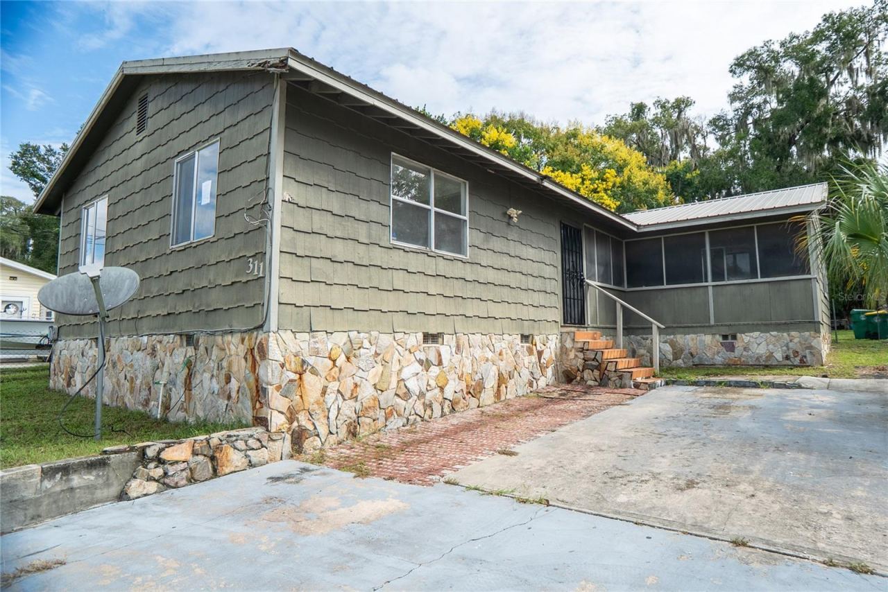 Photo 1 of 20: 311 S Thompson Avenue, DeLand, FL 32720 — Three-bedroom, two-bathroom home offered at $150,000 in Volusia County. Short sale with renovation potential.