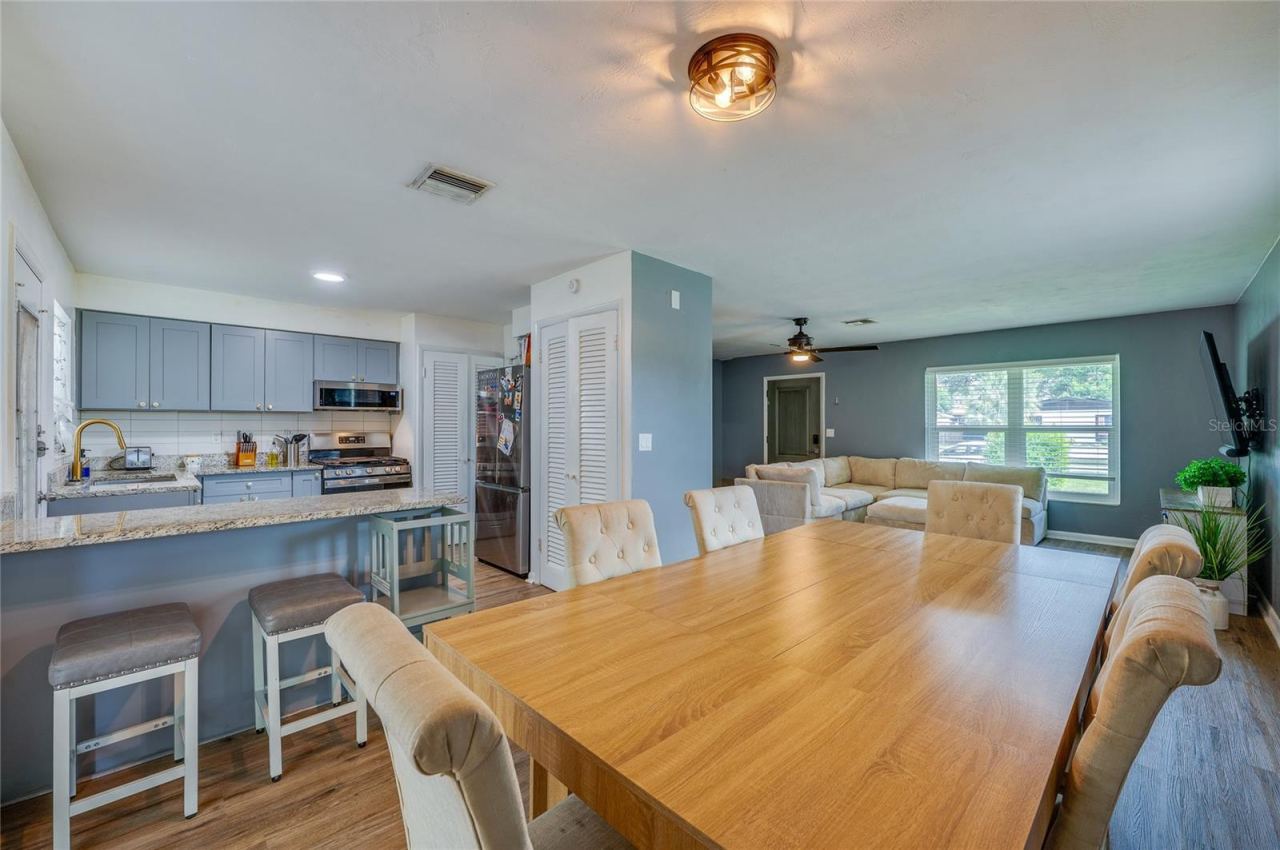 Photo 10 of 20: Open-concept floor plan offering seamless flow between the primary living areas, framed by LVP flooring and overhead lighting.