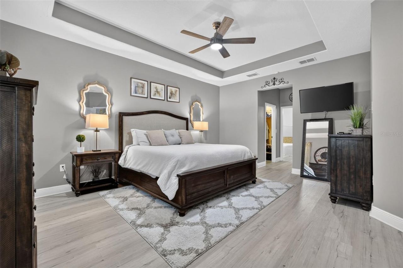 Photo 4 of 20: Large primary bedroom suite with tray ceiling and dual walk-in closets.