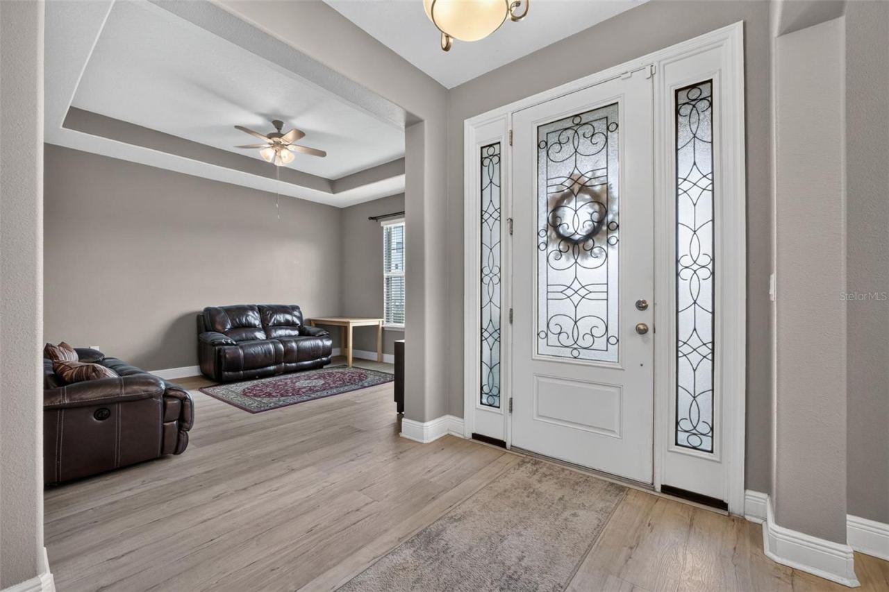 Photo 13 of 20: Foyer towards spacious bonus room w/tray ceiling.