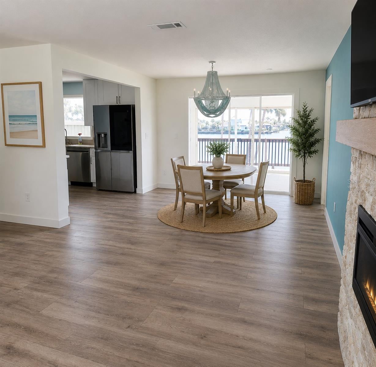 Photo 10 of 20: Virtually Staged. Dining Room open to Living Room, kitchen, and florida room with a view of the water