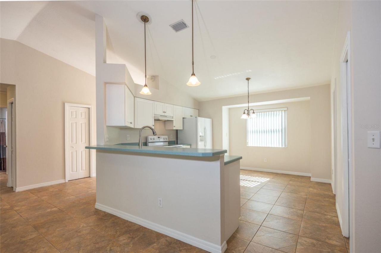 Photo 10 of 20: The kitchen is adjacent to the living room. To the left is a storage closet in the Foyer.