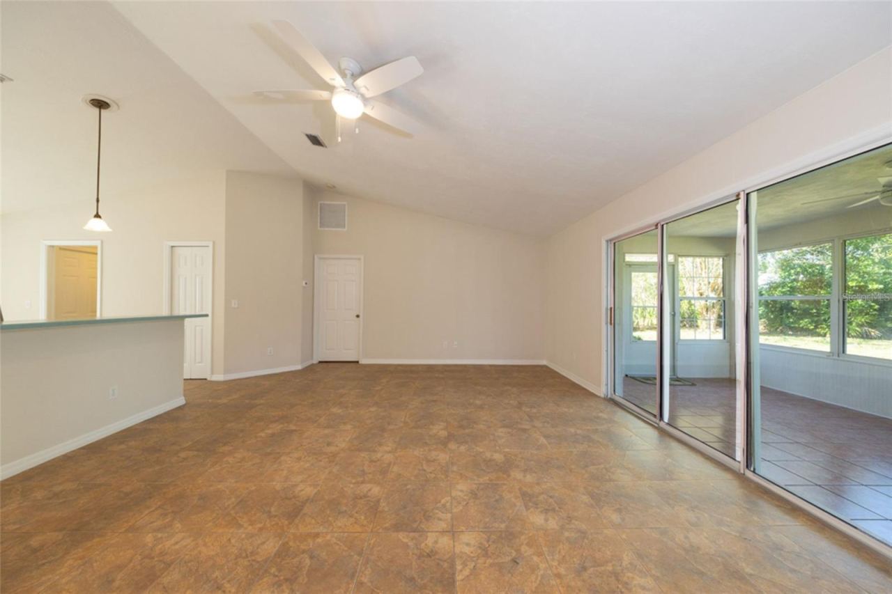 Photo 4 of 20: large living room, looking towards primary bedroom. kitchen to the left, Florida room to the right.