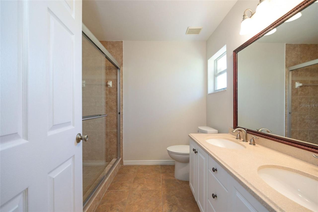 Photo 19 of 20: Primary bath has dual vanities and updated shower.