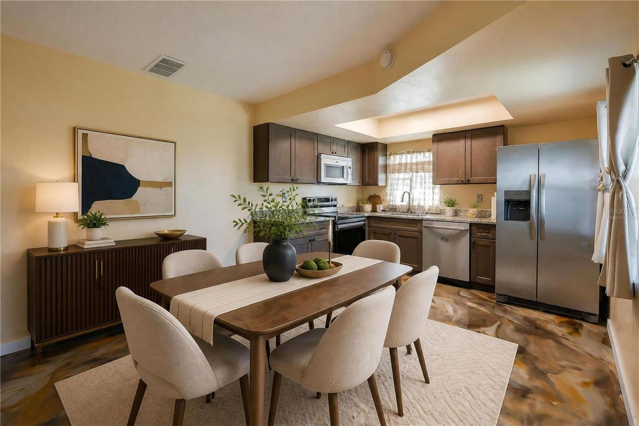Photo 10 of 20: Virtually Staged - Functional kitchen equipped with stainless steel appliances, dark wooden cabinetry, granite countertops, and epoxy flooring.