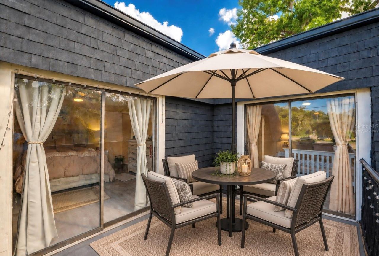 Photo 20 of 20: Virtually staged spacious upper balcony showing dual sliding glass door entry points to the interior living spaces.