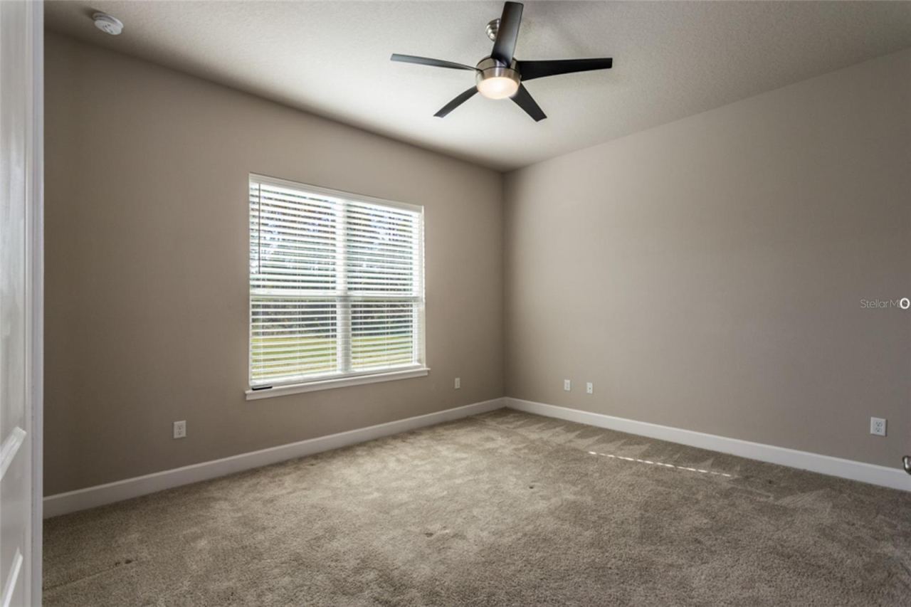 Photo 15 of 20: Primary bedroom -- looks out towards the wooded area