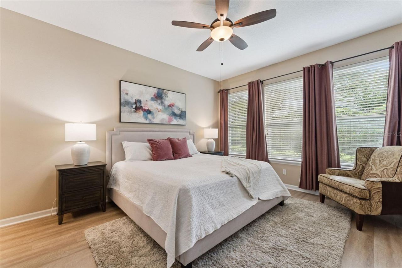 Photo 17 of 20: 12'6" x 15' Primary Bedroom w/ luxury vinyl floor & a ceiling fan