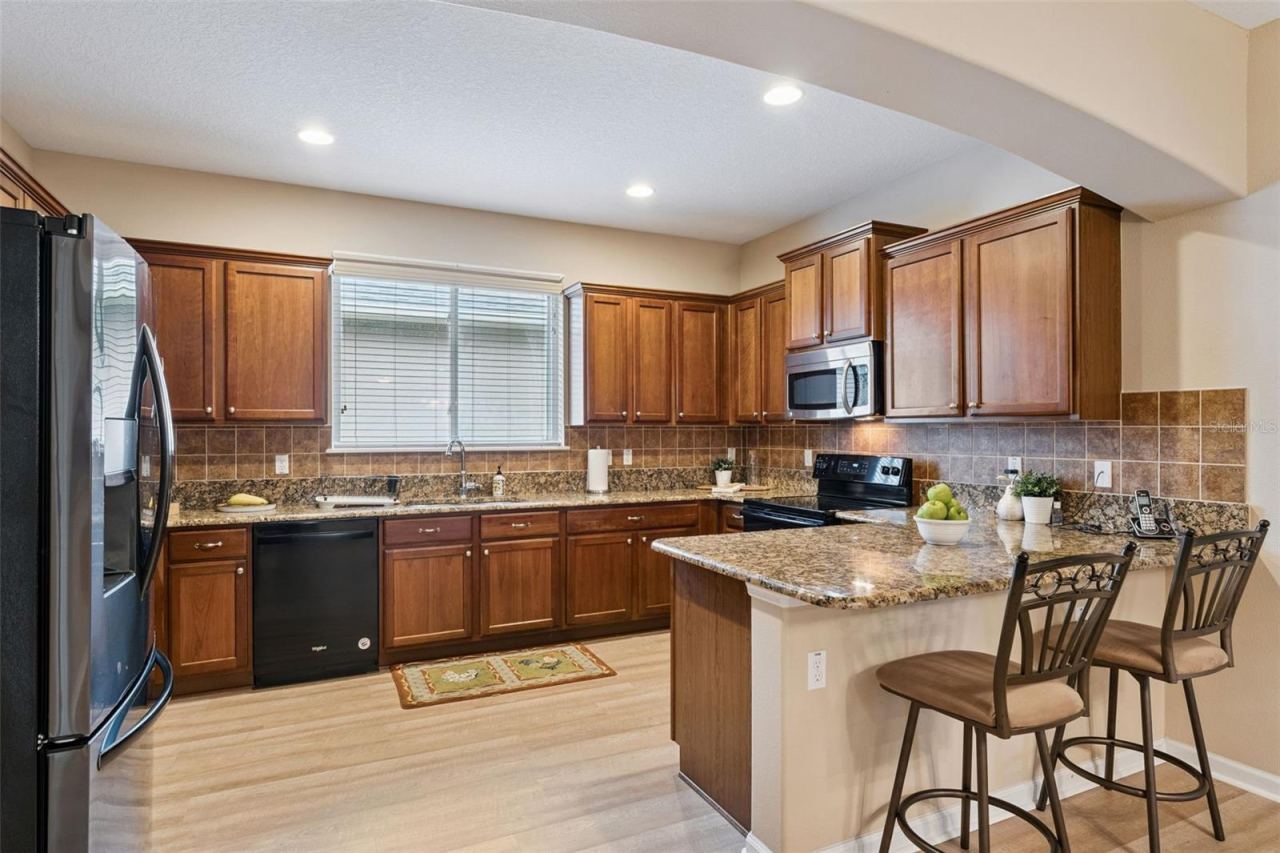 Photo 4 of 20: 11' x 14'6" Kitchen w/ 36" Maple cabinets, tile backsplash & granite countertops
