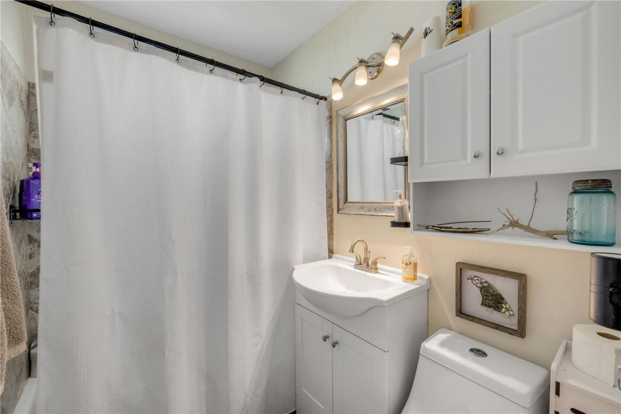 Photo 12 of 20: Bathroom with a vanity and tub/shower combination.