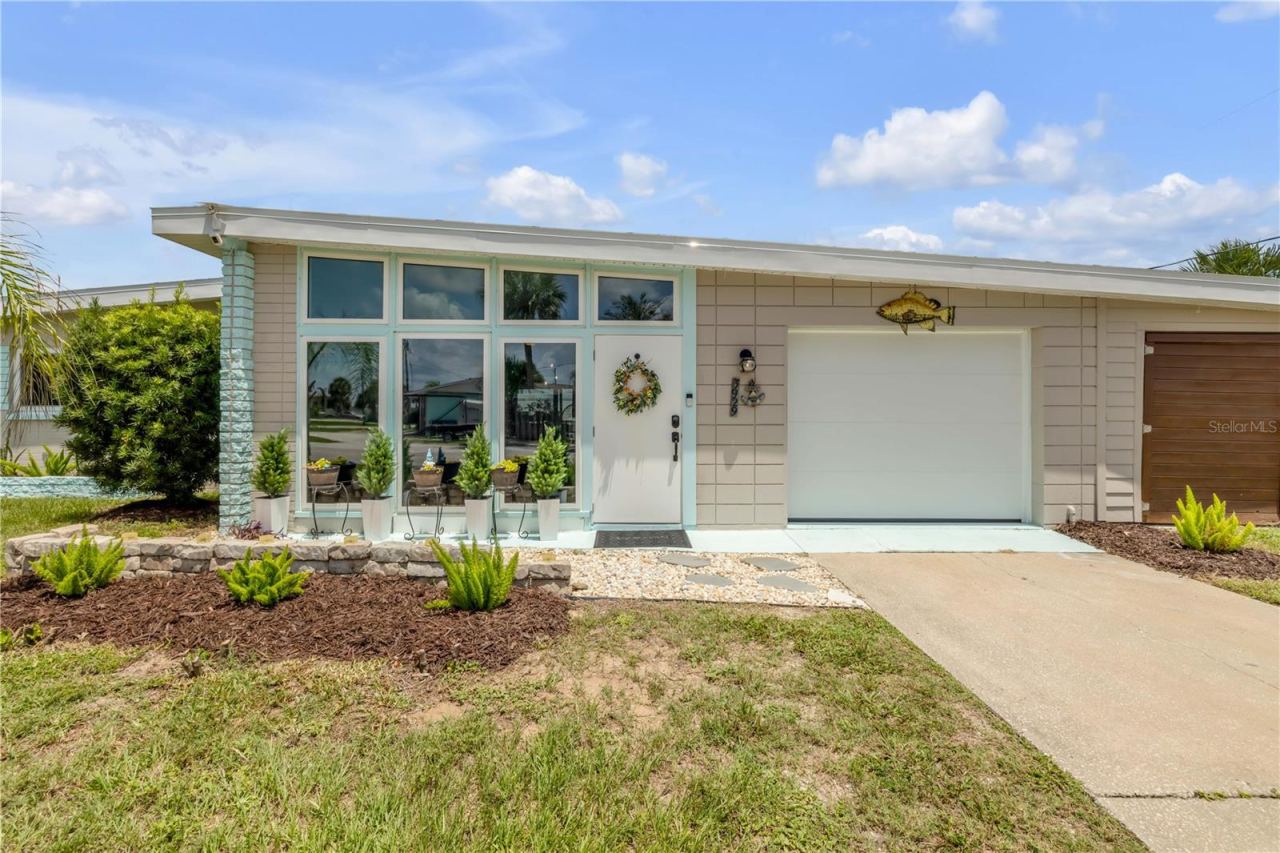 Photo 6 of 20: Front entry with enclosed porch and attached garage.