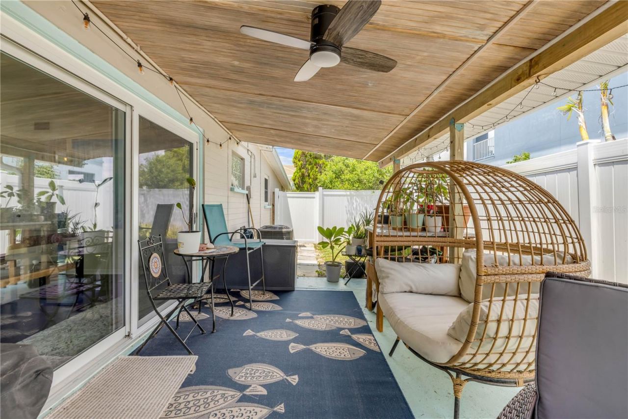 Photo 5 of 20: Covered patio with outdoor seating and a hanging chair.