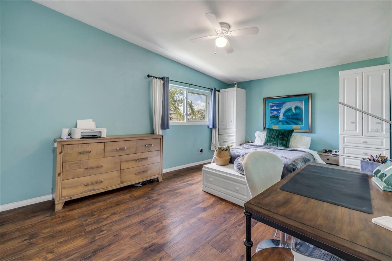 Photo 11 of 20: Bedroom with windows, ceiling fan and coastal-blue walls.