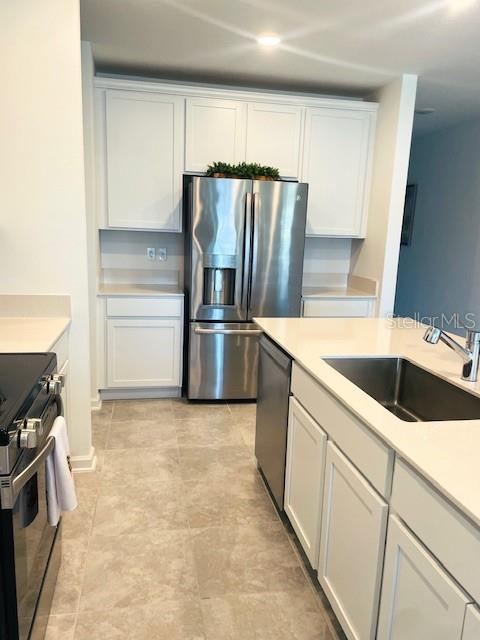 Photo 6 of 20: Kitchen w/Quartz Countertops & Stainless Steel Appliances & French Door Fridge