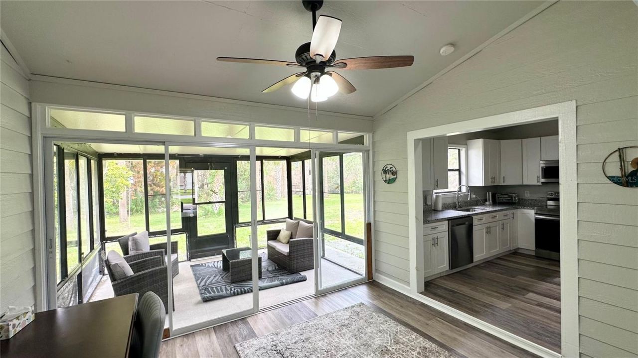 Photo 11 of 20: Florida room view from main living area toward back screened porch.