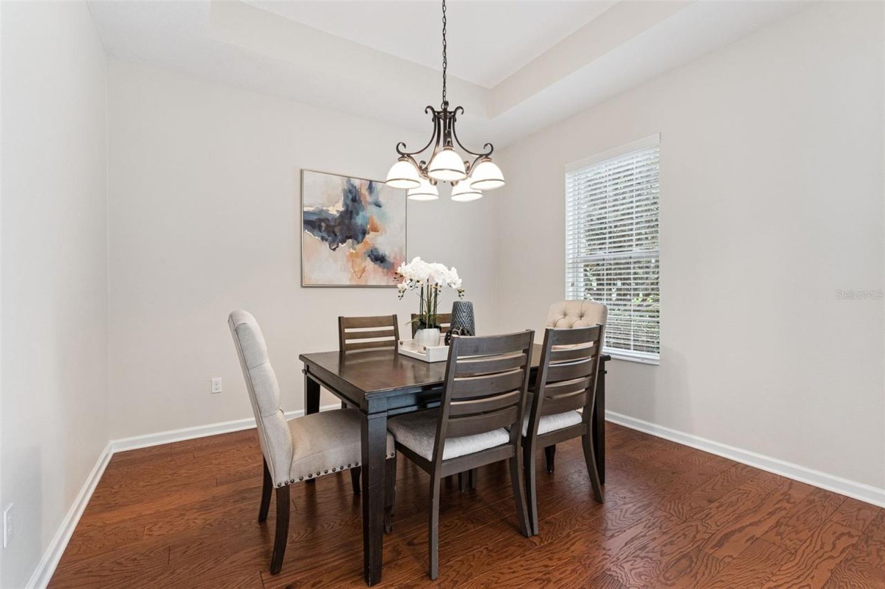 Photo 6 of 20: 11'6" x 11'9" Dining Room w/ a tray ceiling & engineered wood flooring
