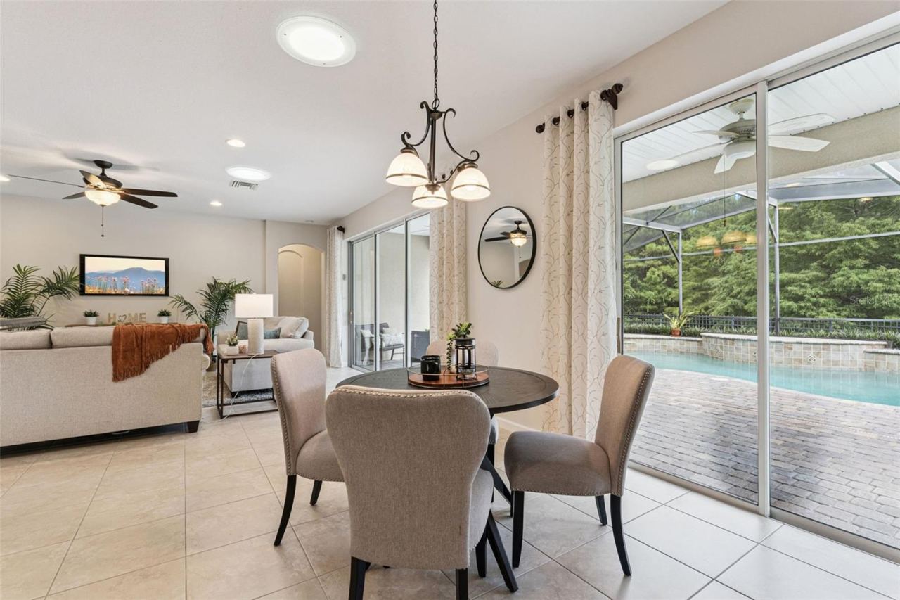 Photo 19 of 20: View of the screen enclosed solar panel heated pool from the Dinette area