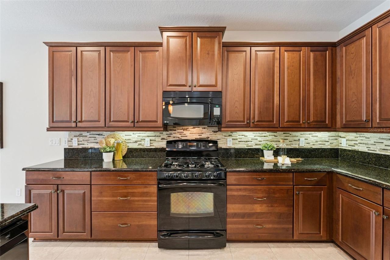 Photo 9 of 20: Kitchen w/ Pot & Pan drawers, pull-out shelving & a 5-burner natural gas convection range