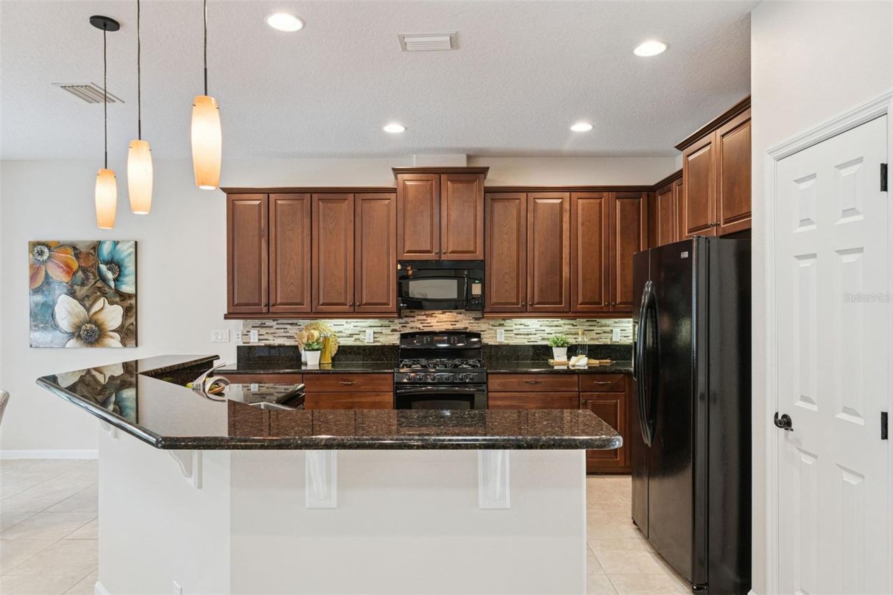 Photo 10 of 20: Kitchen w/ pendant lighting above the breakfast bar