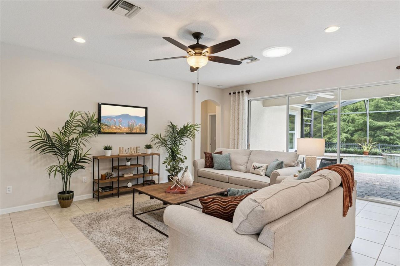Photo 14 of 20: 17' x 21' Great Room w/ 2 solar tubs, recessed lighting & a ceiling fan