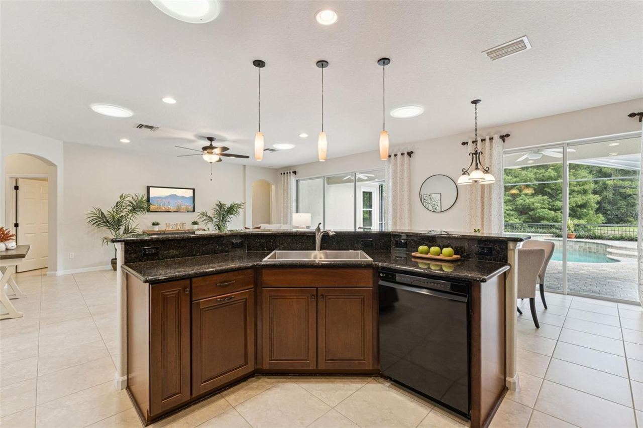 Photo 13 of 20: View of the Great Room & screen enclosed heated pool from the Kitchen area