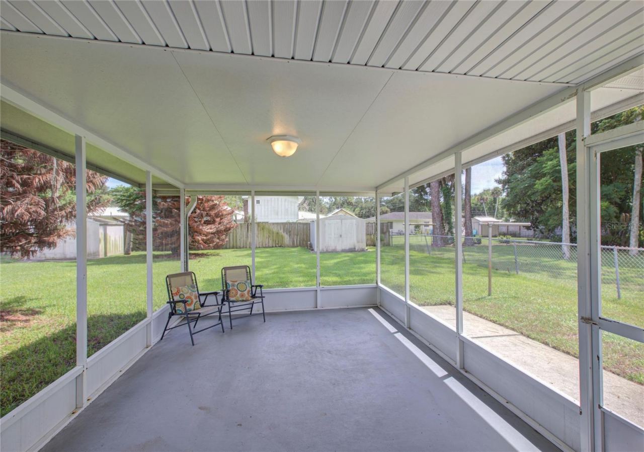 Photo 17 of 20: SCREENED PORCH, FENCED BACK YARD WITH 2 UTILITY SHEDS
