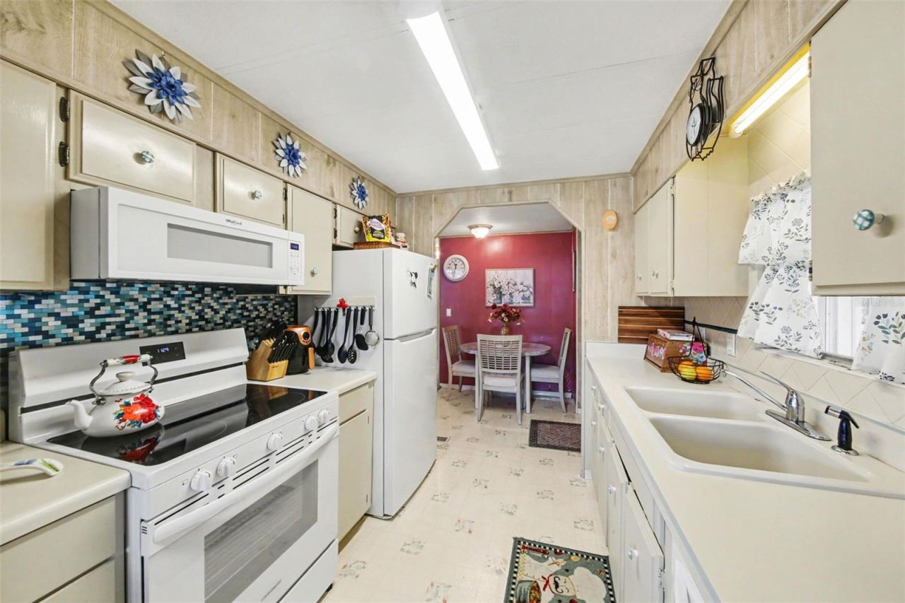 Photo 3 of 17: Galley kitchen with natural light coming in from the window.