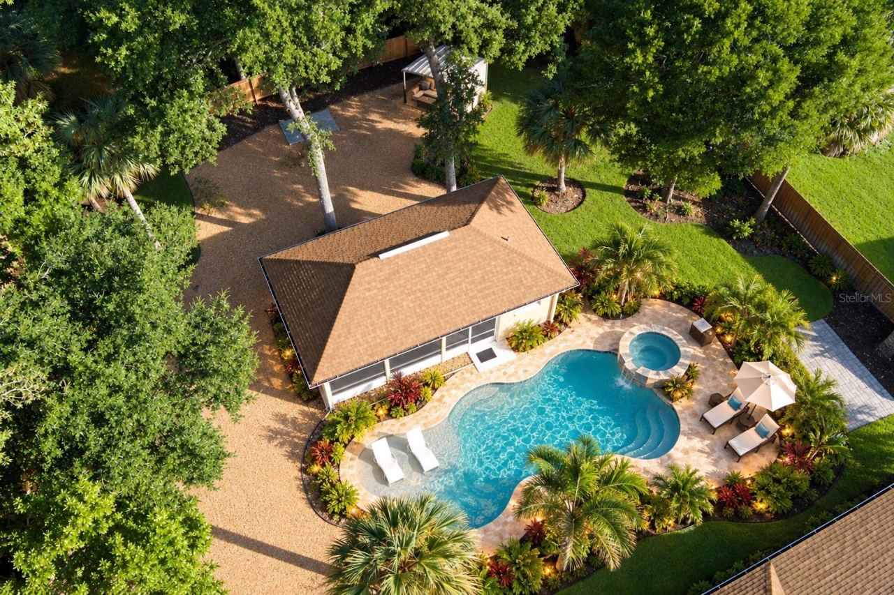 Photo 2 of 20: Aerial Screened Building with a Staged Pool