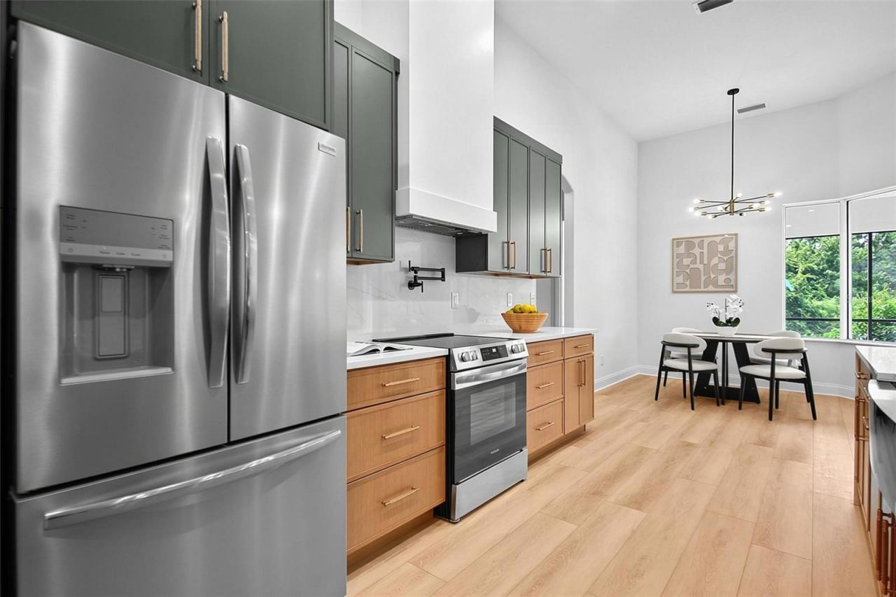Photo 13 of 20: Again, the refrigerator is framed with custom design of the wood cabinets, range, and custom range hood.