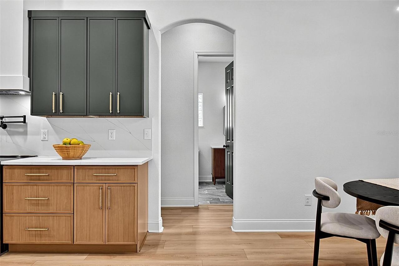Photo 17 of 20: This kitchen look shows the gorgeous curve door frame leading into the hallway to the guest bathroom, 3rd guest bedroom