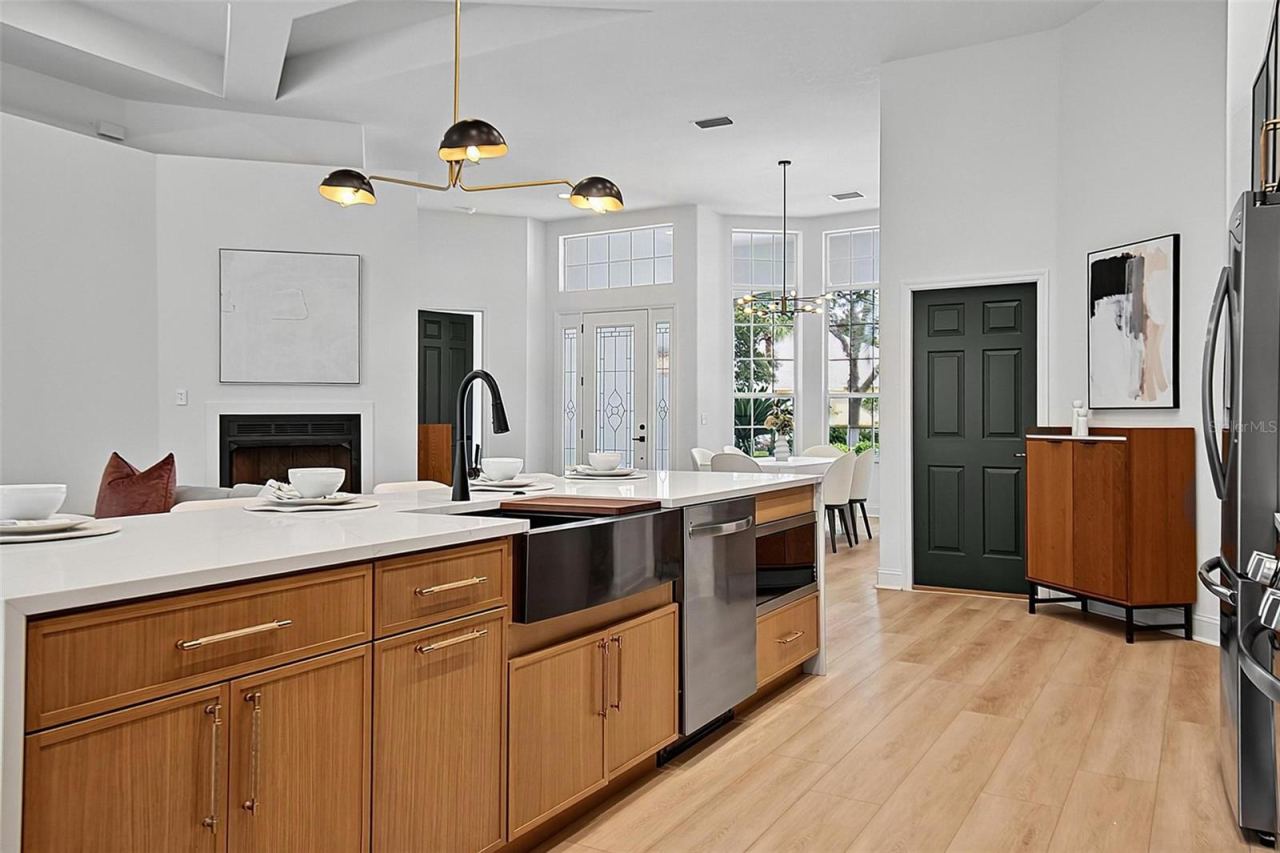 Photo 12 of 20: The beautiful crafted wood cabinets frame the sleek design of the black fixtures, farm house sink, inset microwave and dishwater.